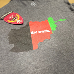 Gray t-shirt with a red and green graphic and 'did work.' text on a plain background