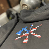 Black jacket with a colorful logo on a blurred gym background