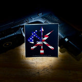 Light-up sign with American flag and crossbow design on a wooden surface.