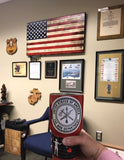 The logo sticker on a coffee mug with some USMC in the background